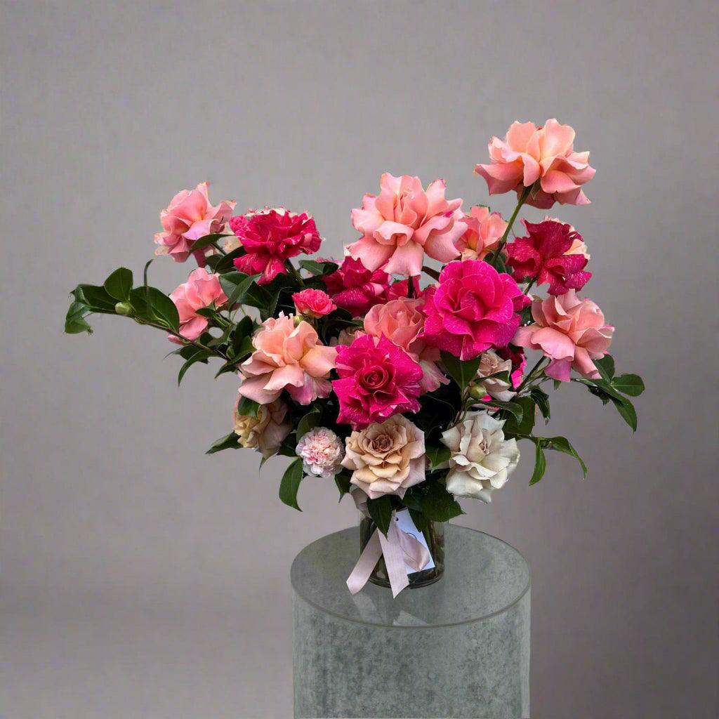 This pink and white flower bouquet features a romantic mix of dahlias, roses, and garden blooms, perfect for gifting or brightening any room. Handcrafted by Herbivore Florals, this fresh flower arrangement blends soft pink tones with delicate white accents for a timeless, elegant look.