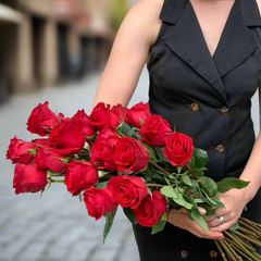 Large bunch of a dozen red roses held by one of Herbivore's Florists