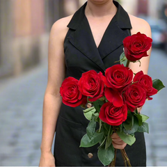 Large bunch of a dozen red roses held by one of Herbivore's Florists