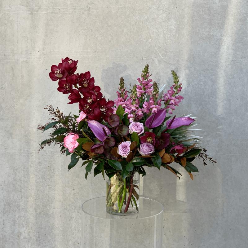 Purple themed flower bouquet with purple roses and purple orchids