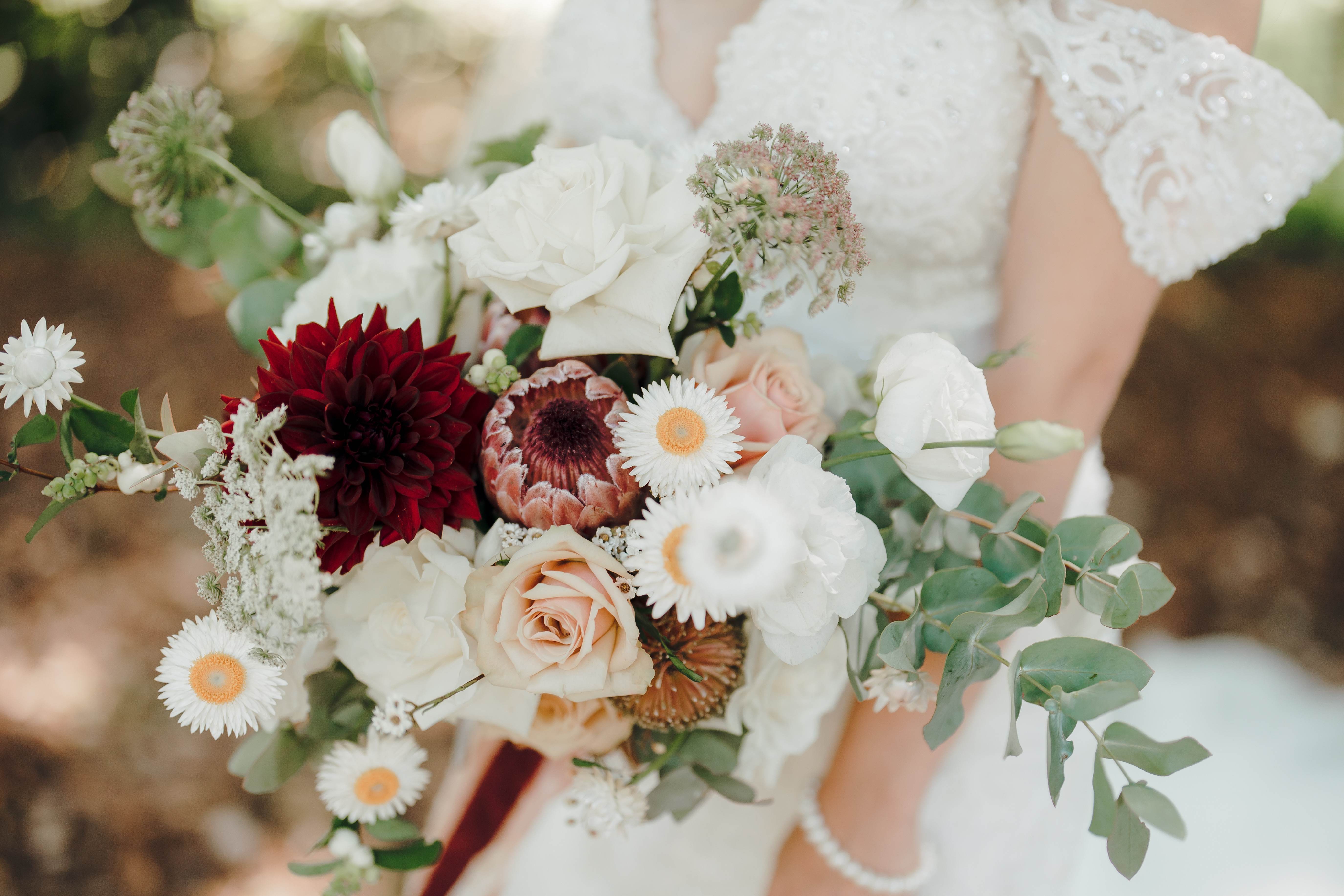 Fresh, classic bridal bouquet with roses and daisies with some green foilage