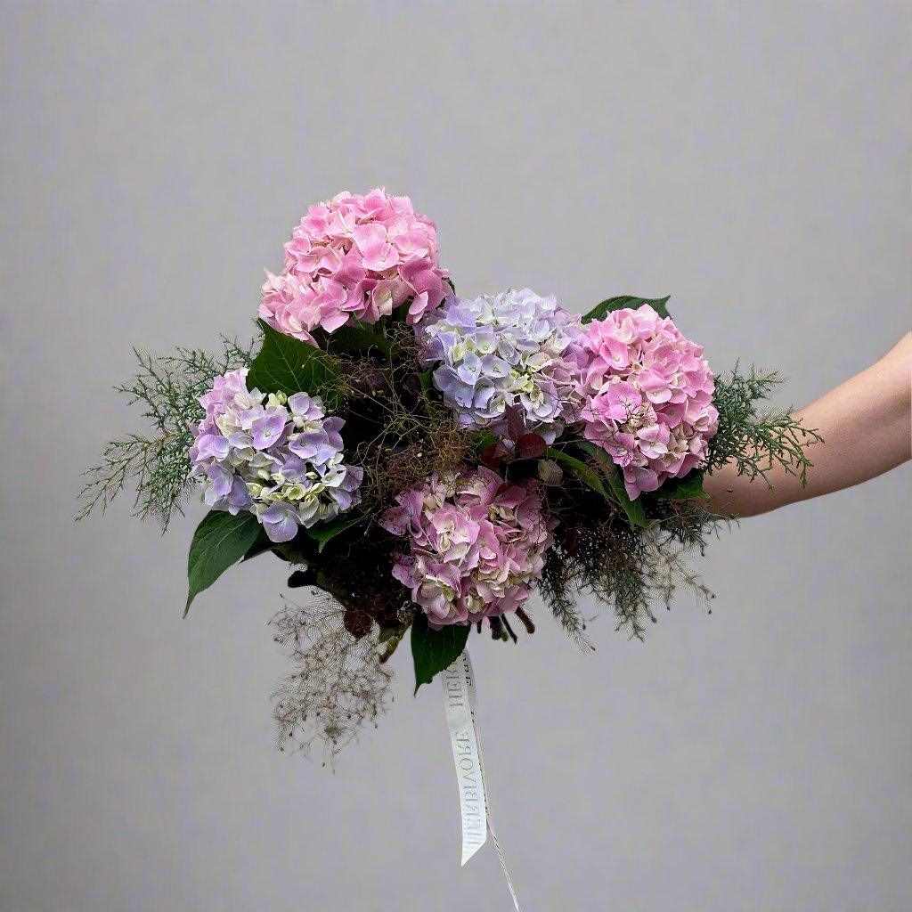 Small bunch of pink and purple hydrangea in a tied posy 