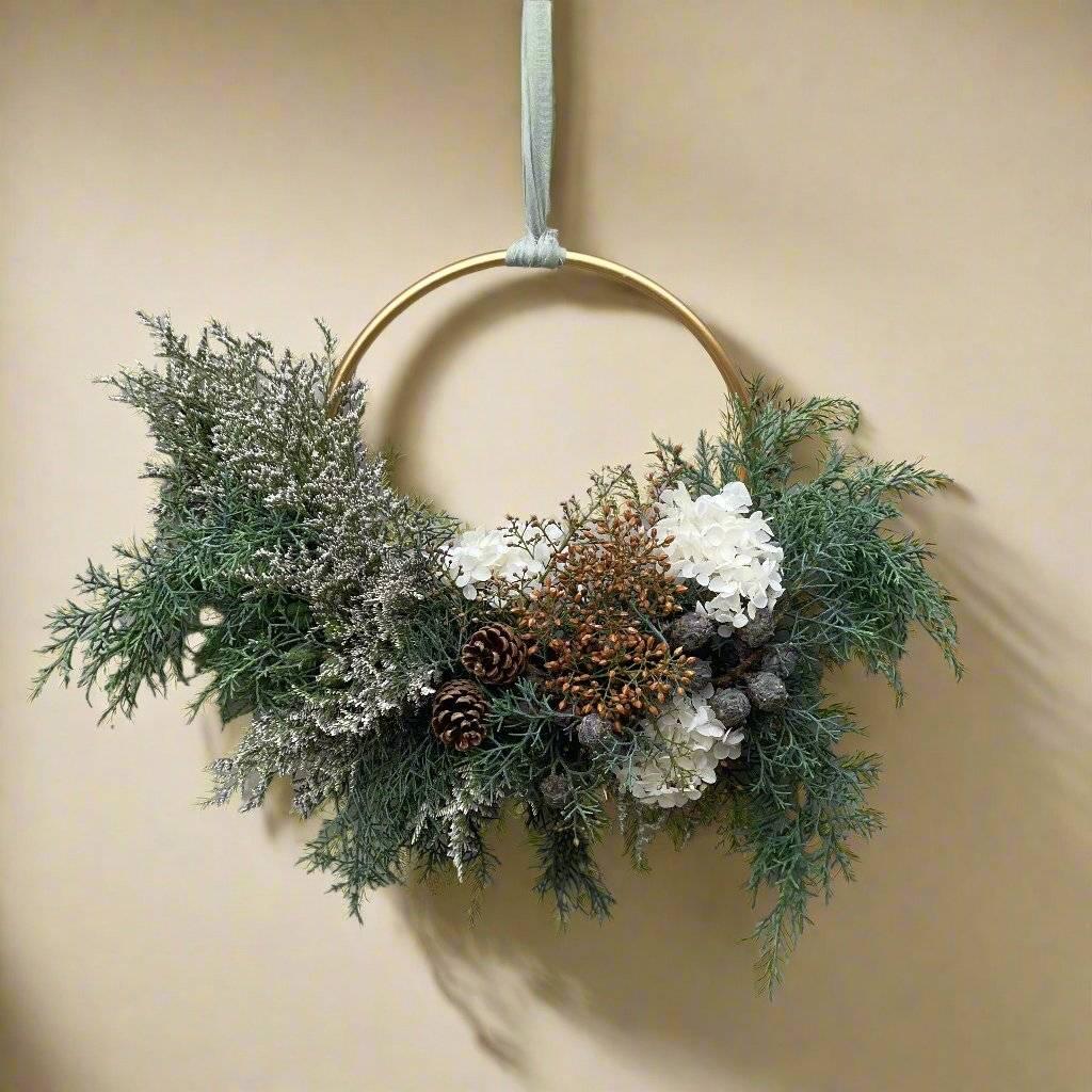 Small Christmas themed floral wreath with pine foliage and white hydrangea