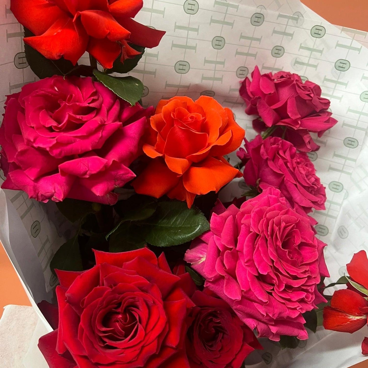 Close up of a small bunch of valentines day roses wrapped in white paper