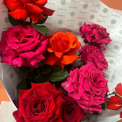 Close up of a small bunch of valentines day roses wrapped in white paper