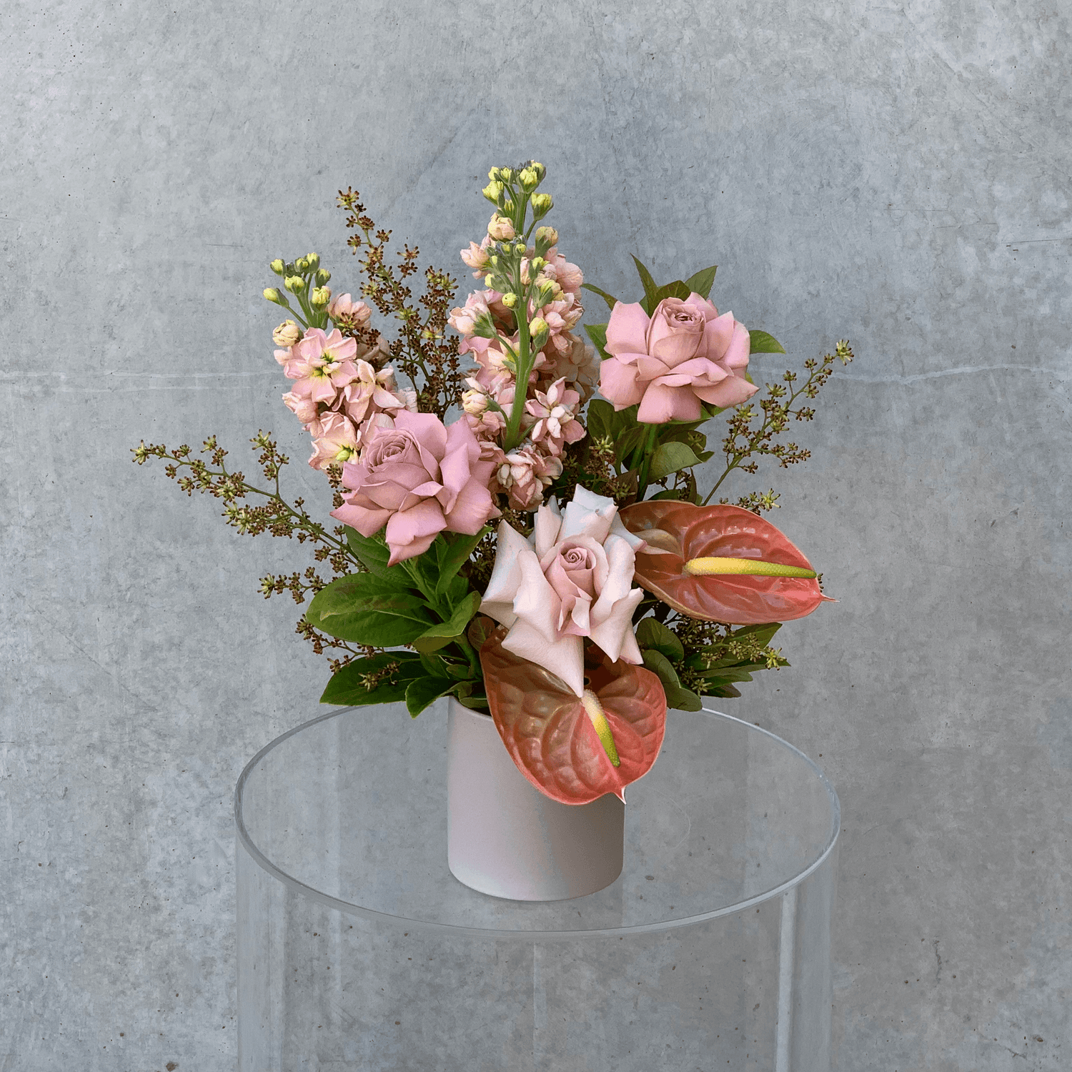 Small vase arrangement featuring assorted taupe & nude toned flowers