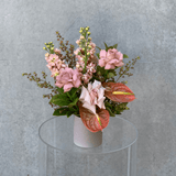 Small vase arrangement featuring assorted taupe & nude toned flowers